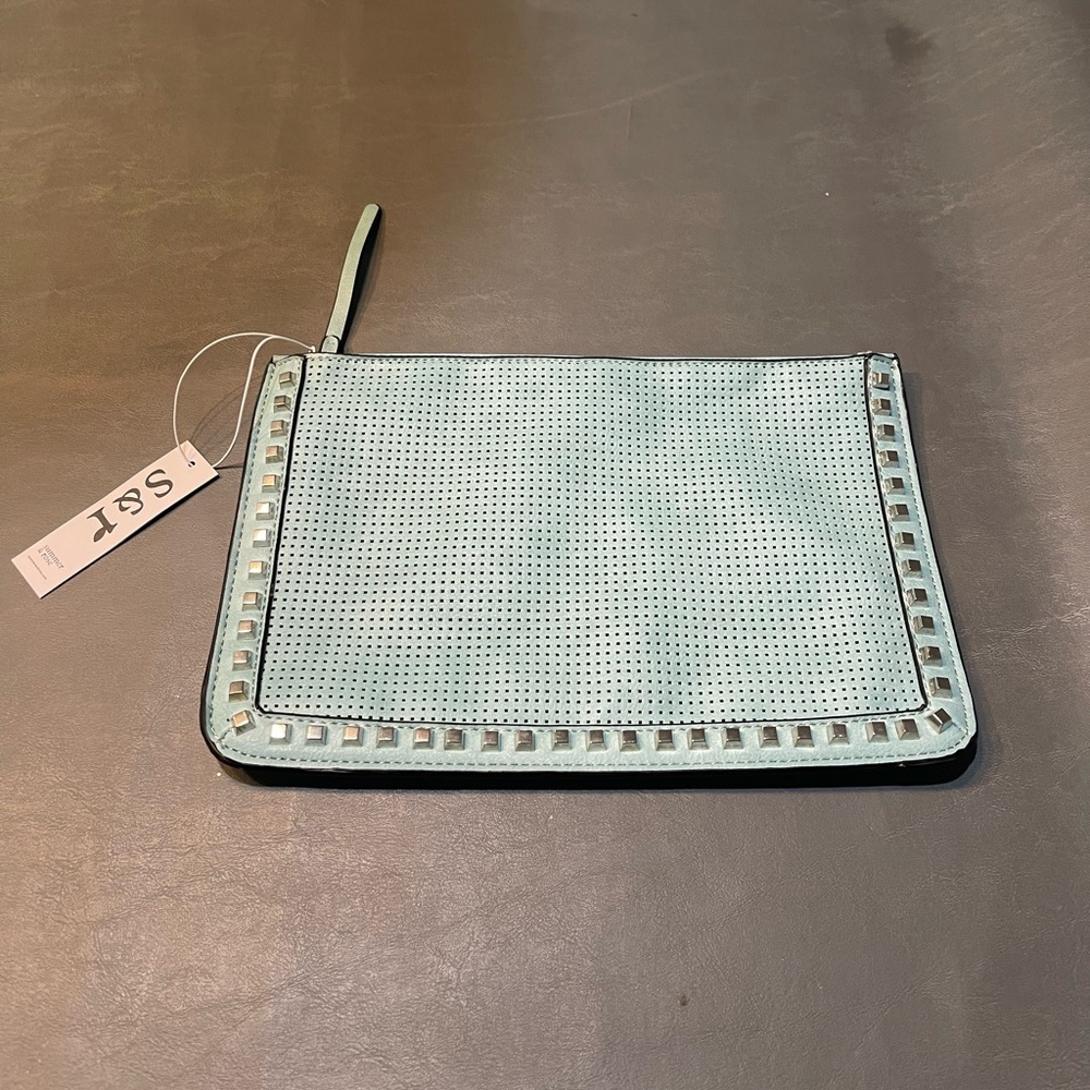 This handbag/makeup bag is a cute turquoise blueish color brand is summer & rose